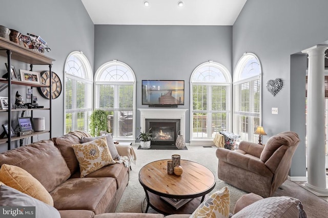 2609 Melissa Ct, Fredericksburg, VA 22408 - living area featuring decorative columns, a high ceiling, carpet floors, and healthy amount of natural light