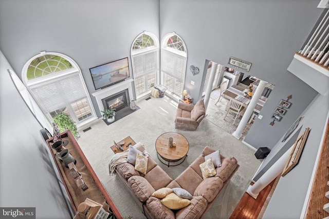 2609 Melissa Ct, Fredericksburg, VA 22408 - living area with a towering ceiling, carpet, a fireplace with flush hearth, and plenty of natural light