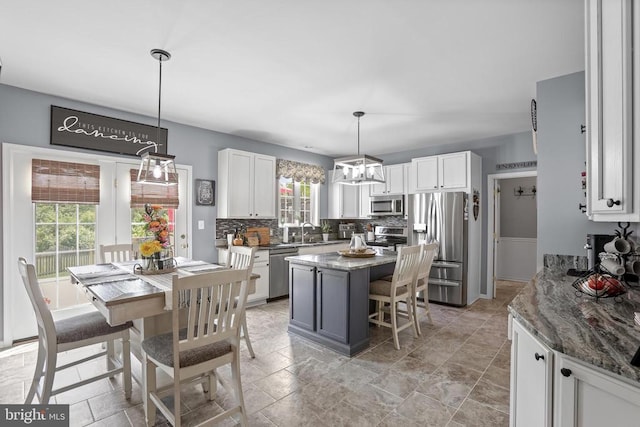 2609 Melissa Ct, Fredericksburg, VA 22408 - kitchen with stainless steel appliances, a sink, backsplash, and white cabinets