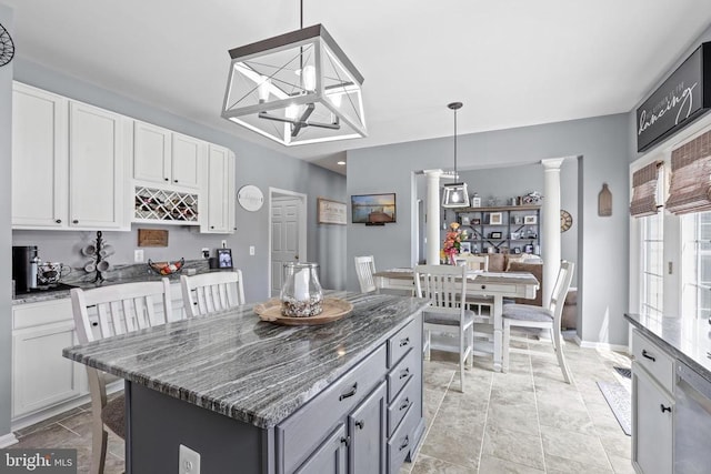 2609 Melissa Ct, Fredericksburg, VA 22408 - kitchen with dark stone counters, a kitchen breakfast bar, and white cabinetry