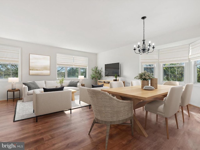 dining space featuring a chandelier and wood finished floors