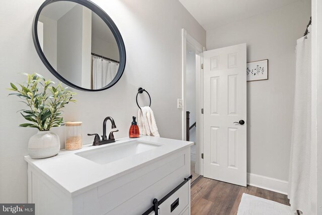 bathroom with vanity and hardwood / wood-style flooring