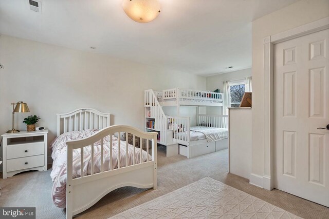 bedroom featuring light colored carpet