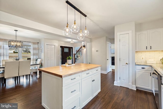 kitchen with white cabinetry, dark hardwood / wood-style floors, pendant lighting, and wood counters