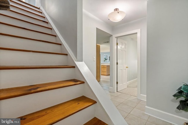 stairway featuring tile patterned flooring