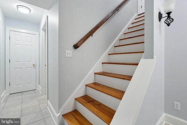 stairway featuring tile patterned flooring