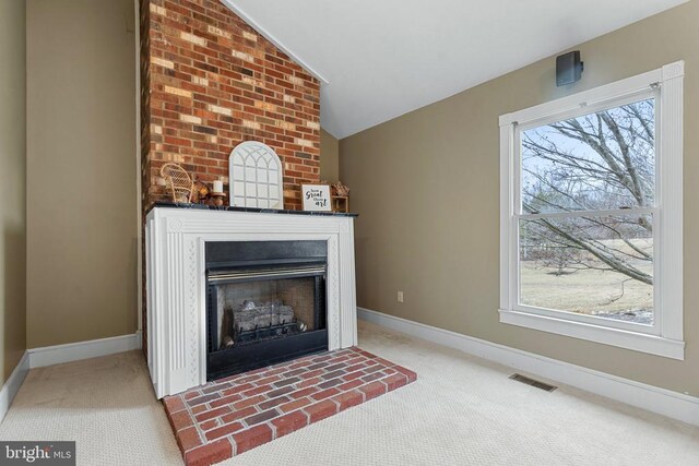 unfurnished living room featuring vaulted ceiling and light carpet