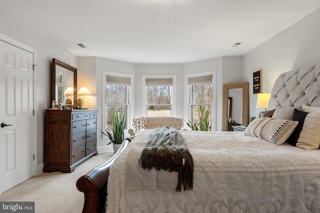 bedroom featuring light carpet