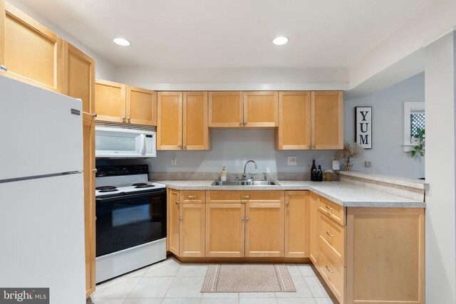 kitchen featuring light brown cabinetry, sink, white appliances, and light tile patterned floors