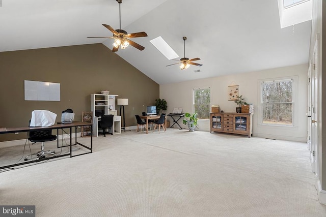 interior space with a skylight, high vaulted ceiling, and ceiling fan