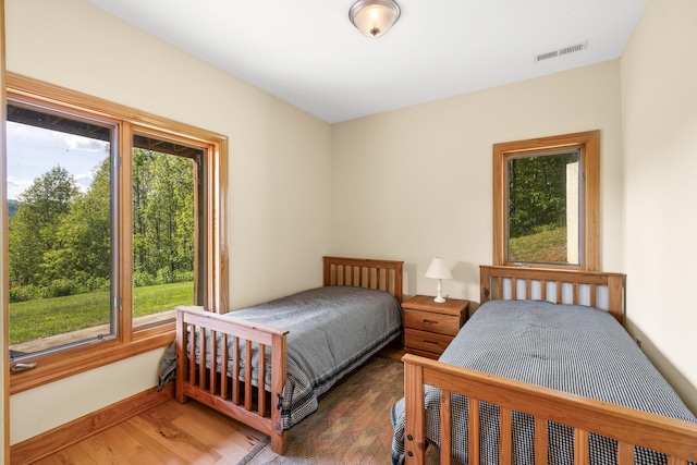 66 Spencer Ln, Lovingston, VA 22949 - bedroom with baseboards, multiple windows, visible vents, and wood finished floors