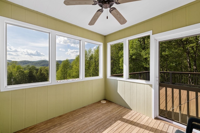 66 Spencer Ln, Lovingston, VA 22949 - unfurnished sunroom with a wooden deck, wood walls, plenty of natural light, and wood finished floors