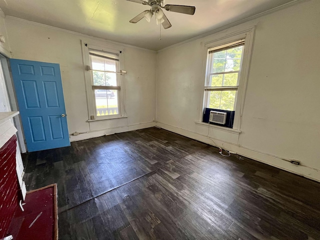 spare room with ornamental molding, wood finished floors, plenty of natural light, a ceiling fan, and baseboards