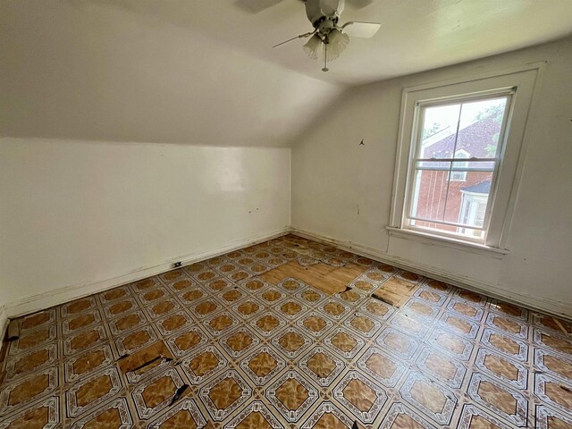 additional living space featuring vaulted ceiling, ceiling fan, and baseboards