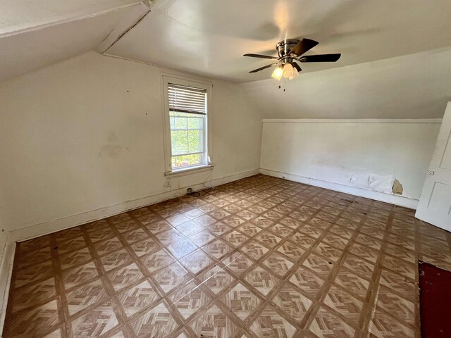 bonus room with lofted ceiling, ceiling fan, and baseboards