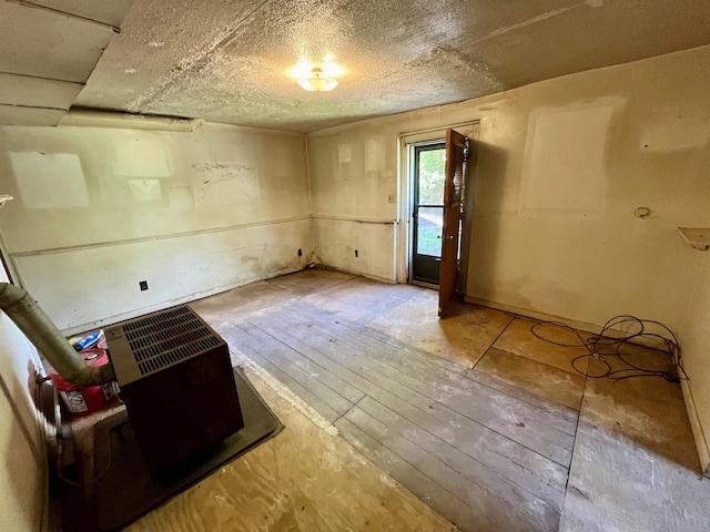 spare room featuring wood-type flooring