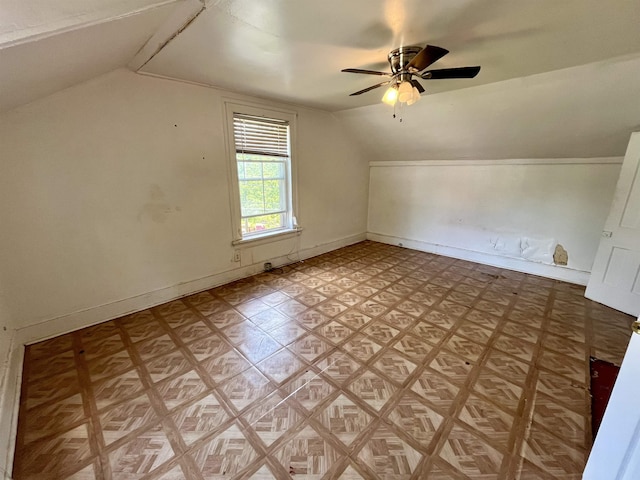 additional living space featuring vaulted ceiling, ceiling fan, and baseboards