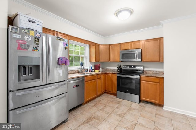 kitchen with stainless steel appliances, a sink, crown molding, and brown cabinetry