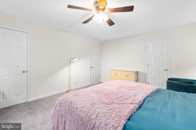 bedroom with carpet flooring, baseboards, and a ceiling fan