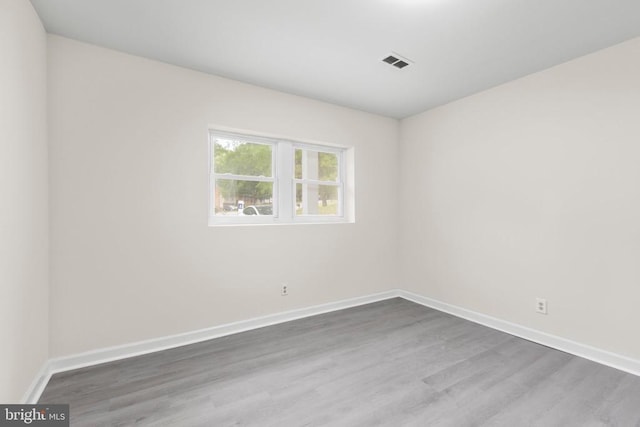 unfurnished room featuring wood finished floors and baseboards
