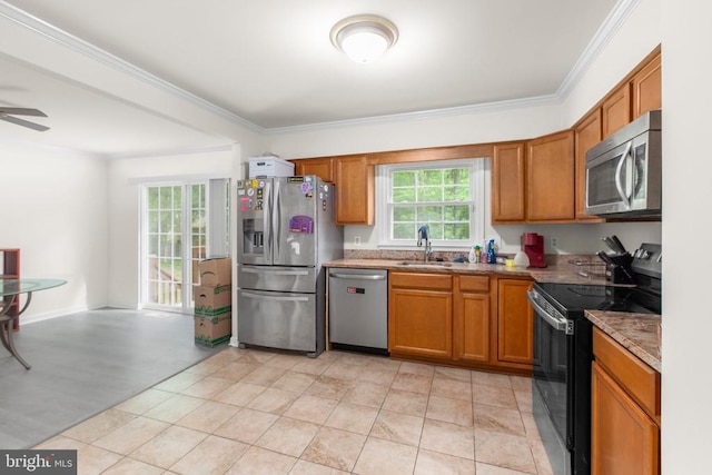kitchen featuring a sink, a ceiling fan, stainless steel appliances, and brown cabinets