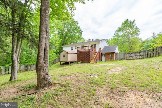 view of yard featuring a wooden deck, a storage shed, stairway, and an outdoor structure