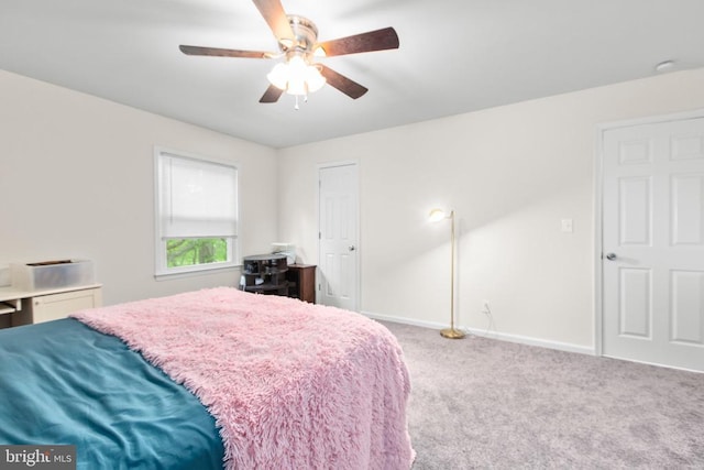 carpeted bedroom with baseboards and ceiling fan