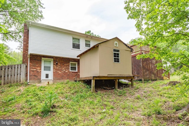 back of house with fence and brick siding