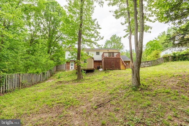 view of yard with stairway, a deck, and an outdoor structure