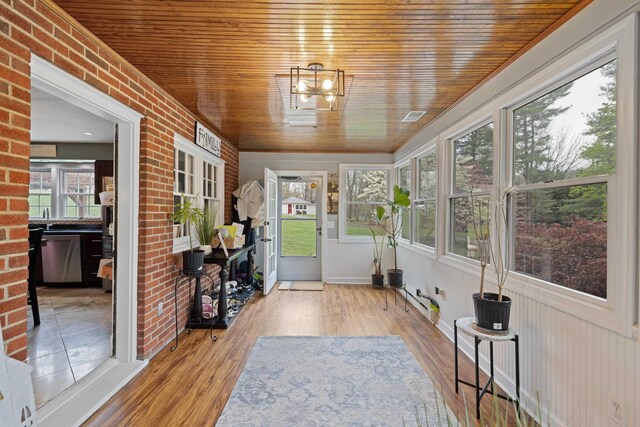 4111 Spotswood Trl, Penn Laird, VA 22846 - sunroom featuring wooden ceiling, healthy amount of natural light, wood finished floors, brick wall, and a chandelier