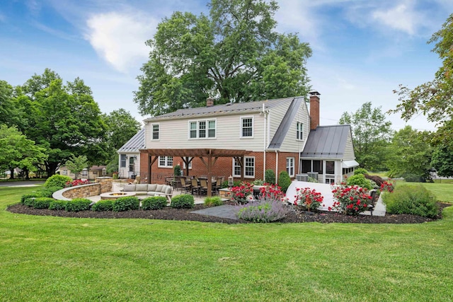 4111 Spotswood Trl, Penn Laird, VA 22846 - back of house with a chimney, brick siding, an outdoor living space with a fire pit, a lawn, and a patio area