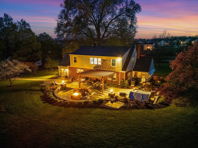 4111 Spotswood Trl, Penn Laird, VA 22846 - back of property at dusk featuring an outdoor fire pit, a patio, a lawn, and a chimney