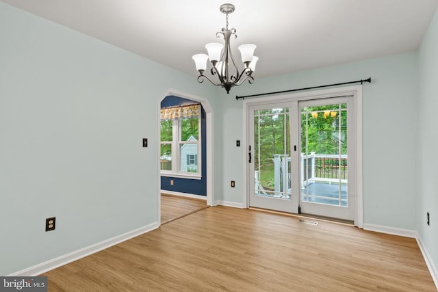 11934 Gardenia Dr, Fredericksburg, VA 22407 - empty room featuring light wood-type flooring, healthy amount of natural light, a chandelier, and baseboards