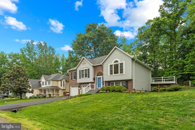11934 Gardenia Dr, Fredericksburg, VA 22407 - bi-level home featuring an attached garage, driveway, a front yard, and brick siding