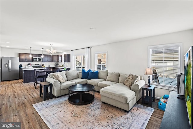 9717 Rockwell Rd, Fredericksburg, VA 22407 - living room with a chandelier and light wood-type flooring