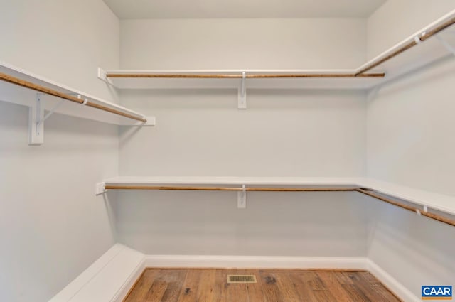 walk in closet featuring hardwood / wood-style floors