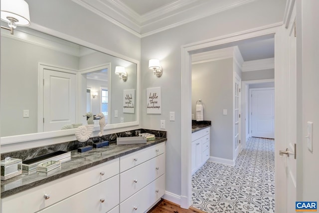 bathroom with ornamental molding and vanity