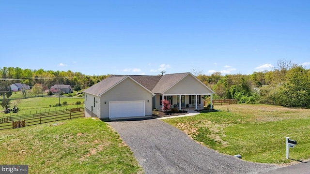 ranch-style house featuring a porch, a garage, and asphalt driveway