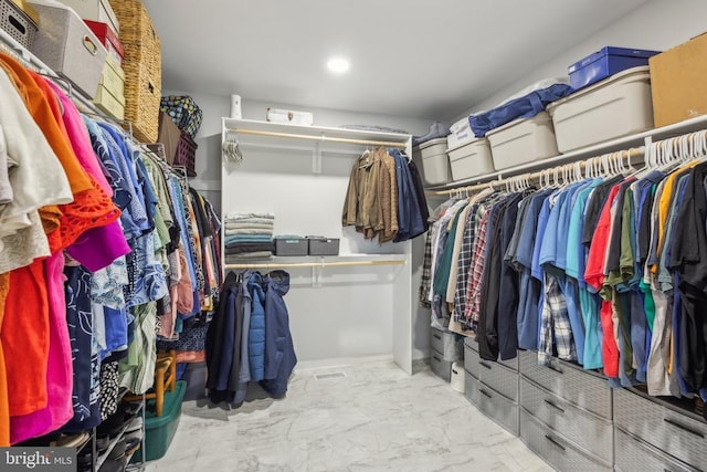 spacious closet featuring marble look tile flooring