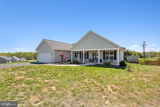 ranch-style house with driveway, covered porch, and an attached garage
