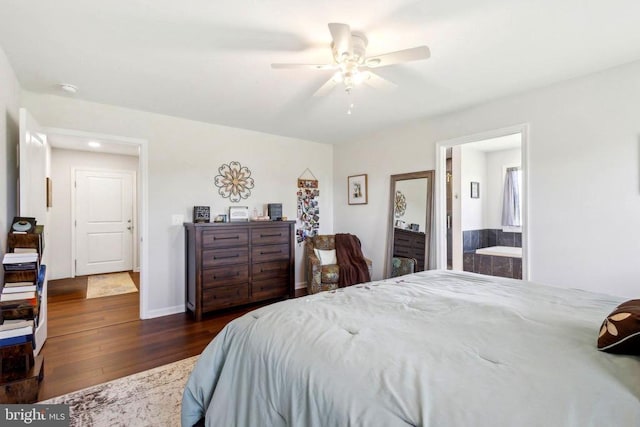 bedroom with wood finished floors, ceiling fan, and ensuite bath