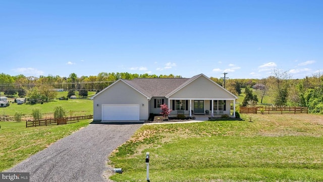 ranch-style house with gravel driveway, an attached garage, and covered porch