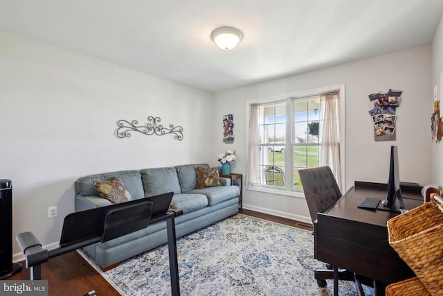 office space with baseboards and wood finished floors