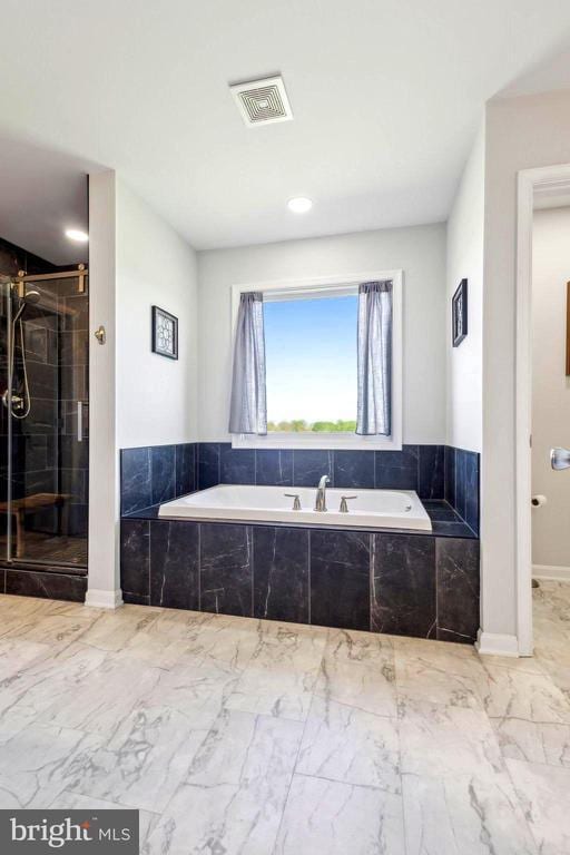 full bathroom with a bath, a shower stall, marble look tile flooring, recessed lighting, and baseboards