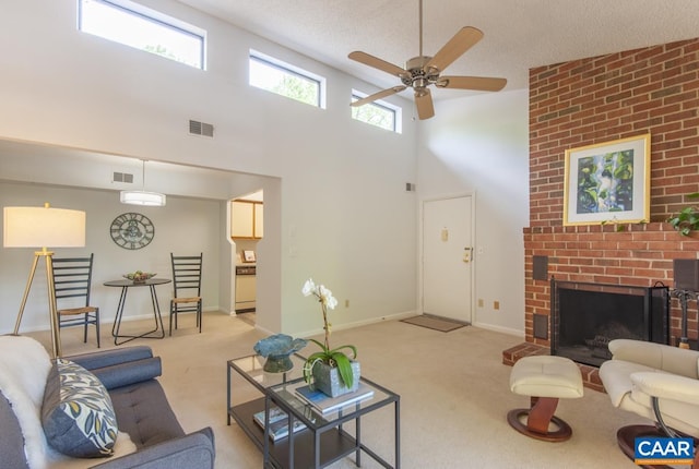 117 Turtle Creek Rd Unit 9, Charlottesville, VA 22901 - living room featuring light colored carpet, ceiling fan, a high ceiling, baseboards, and a fireplace