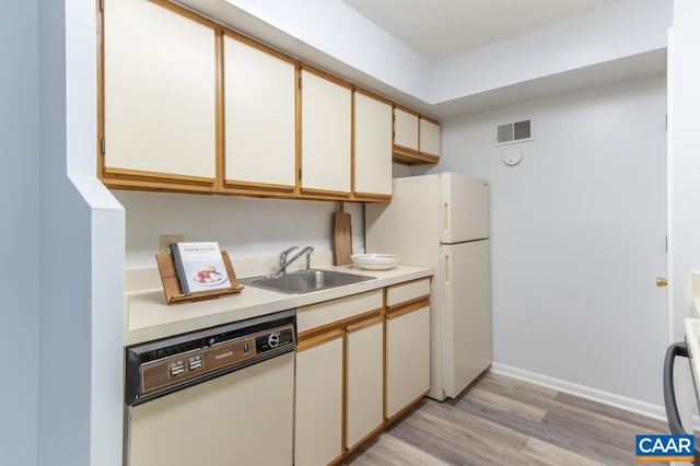 117 Turtle Creek Rd Unit 9, Charlottesville, VA 22901 - kitchen with white appliances, a sink, light countertops, light wood-style floors, and baseboards