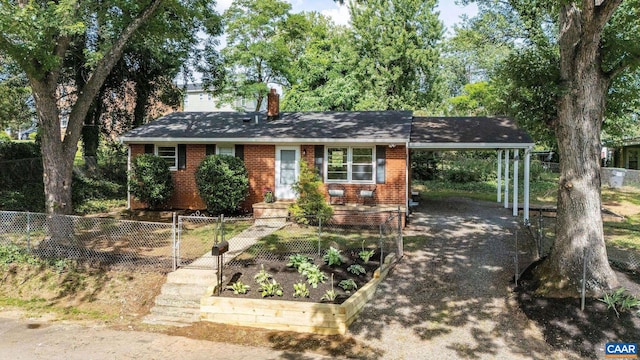 122 Westerly Ave, Charlottesville, VA 22903 - view of front facade featuring a chimney, an attached carport, a fenced front yard, brick siding, and driveway