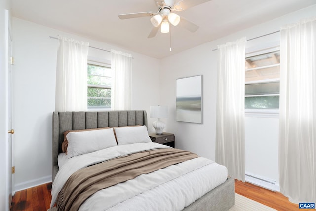 122 Westerly Ave, Charlottesville, VA 22903 - bedroom with a baseboard radiator, wood finished floors, and a ceiling fan