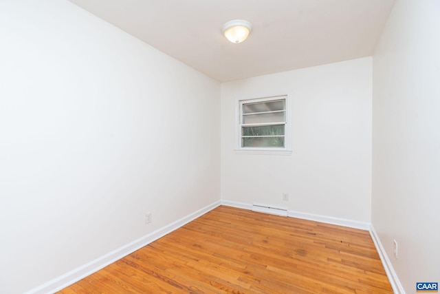 122 Westerly Ave, Charlottesville, VA 22903 - spare room featuring a baseboard radiator, light wood-style floors, and built in shelves