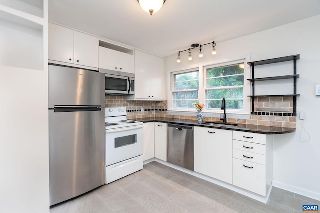 122 Westerly Ave, Charlottesville, VA 22903 - kitchen featuring appliances with stainless steel finishes, white cabinetry, decorative backsplash, open shelves, and light tile patterned floors